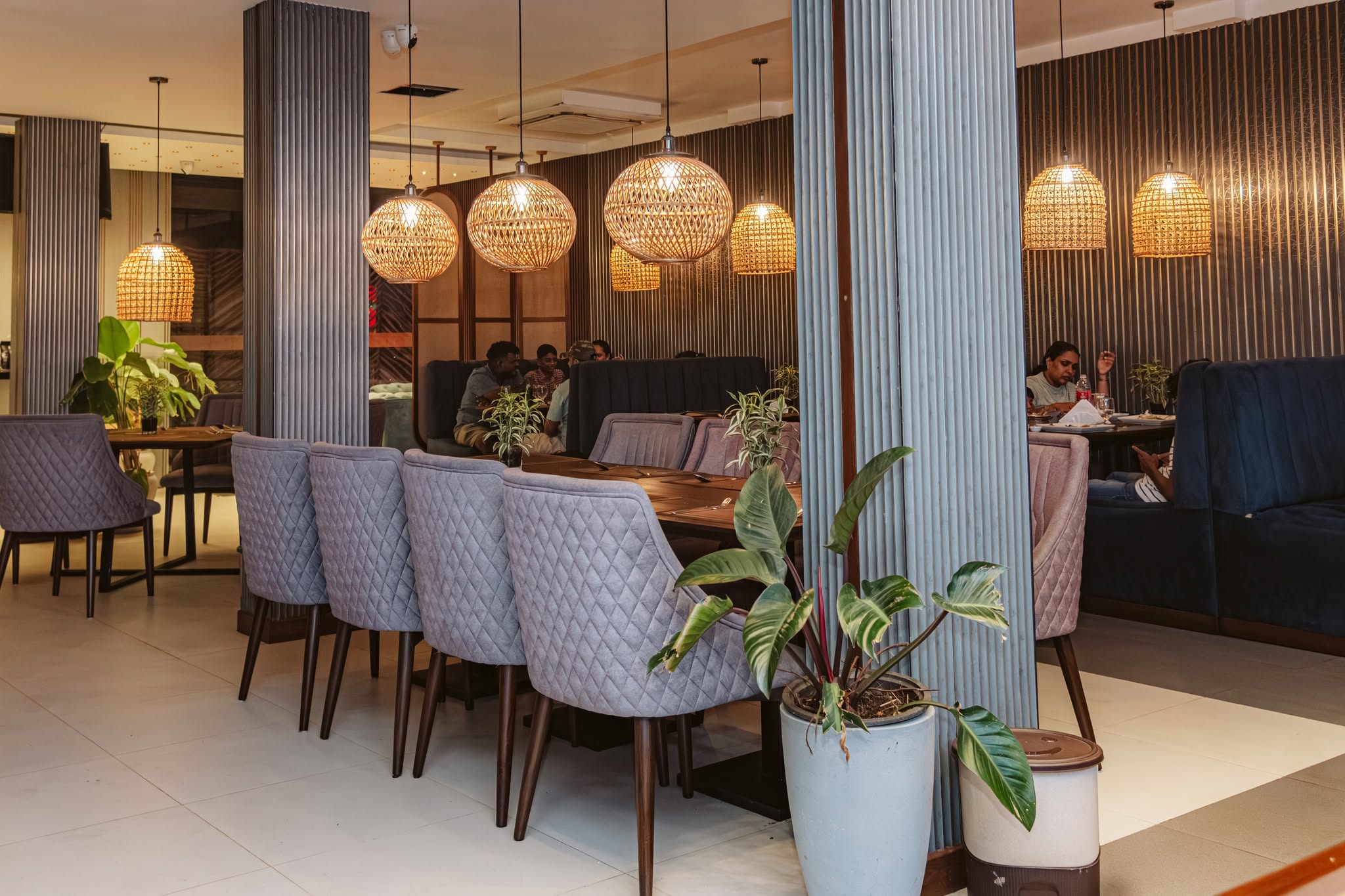 Guests in the Madeena dining room beneath woven lights